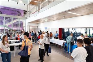 Students and staff in a large open section of a school